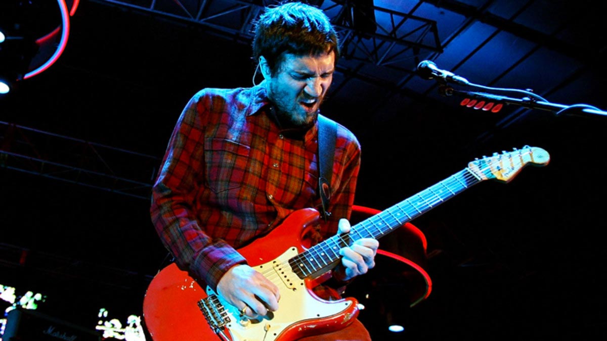 John Frusciante tocando una guitarra roja