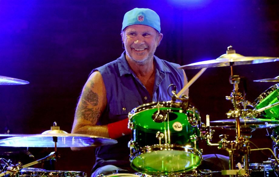 Chad Smith tocando batería mientras sonrie